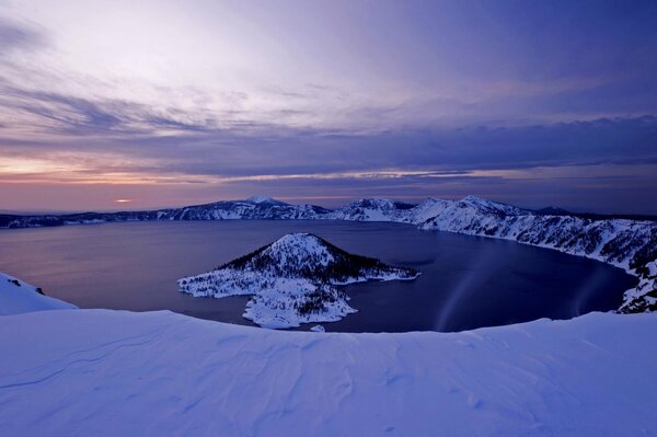 Dawn in the mountains. Around the lake, forest and sky