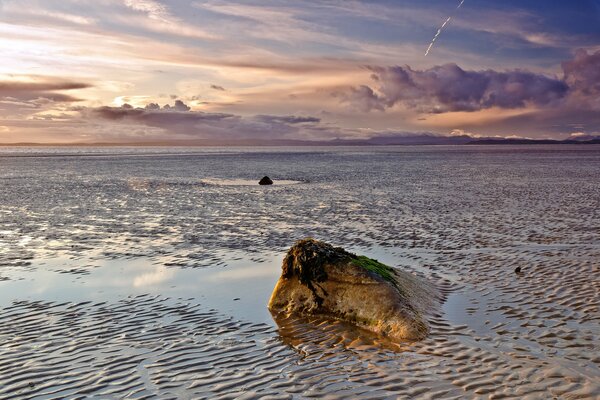 Stone from the sea, ripples on the water