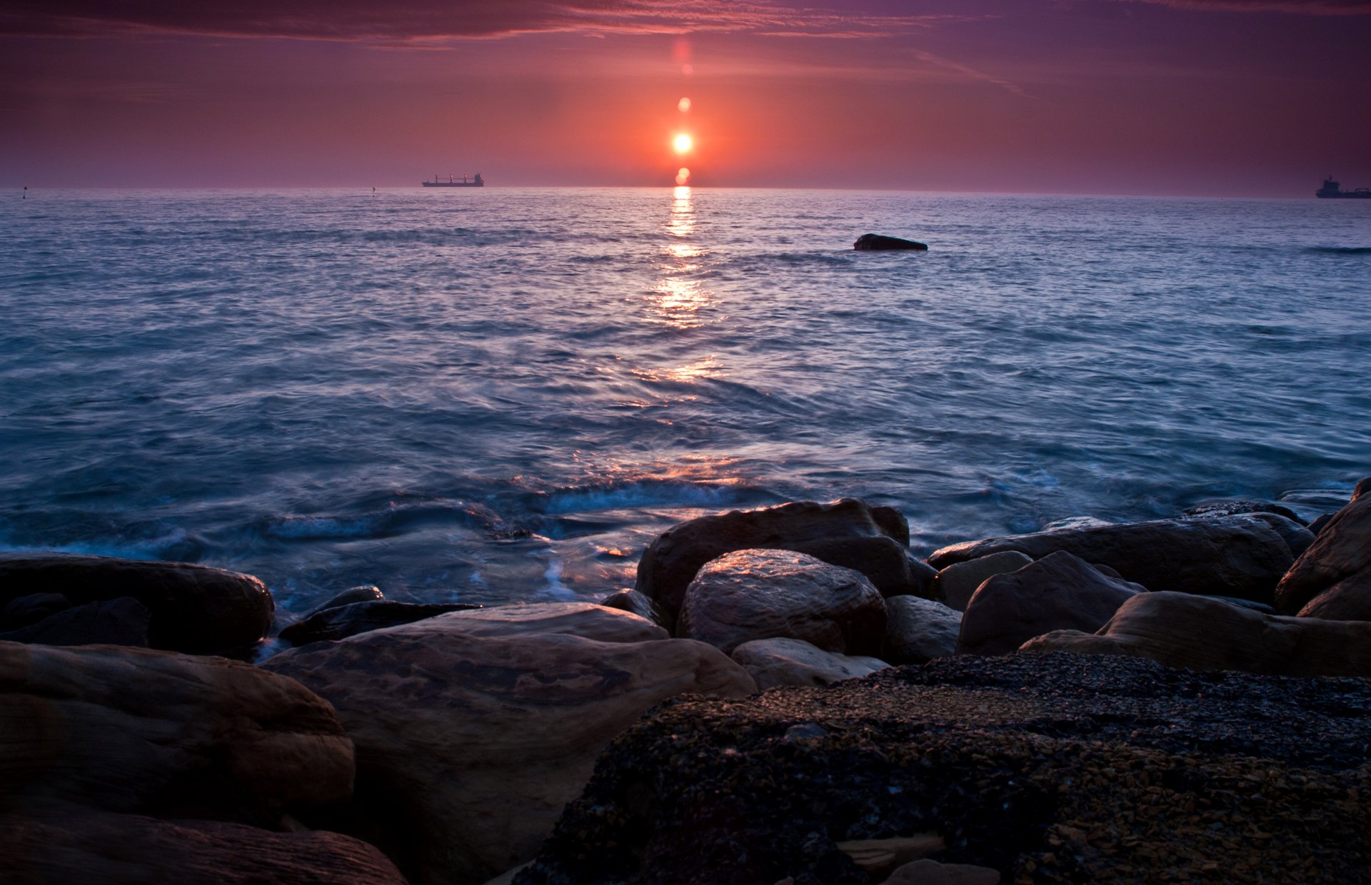 unset sea stones ship