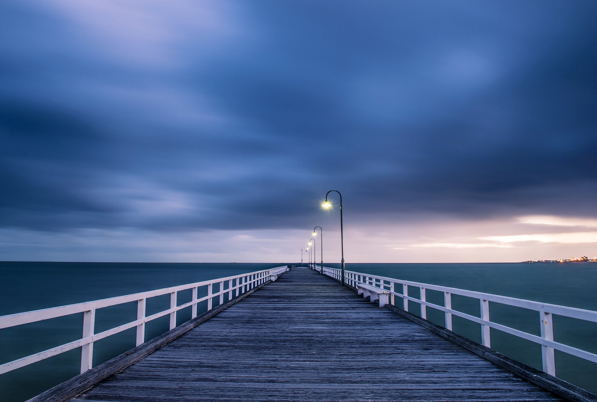 australia ocean wood bridge light lamps sky clouds the storm