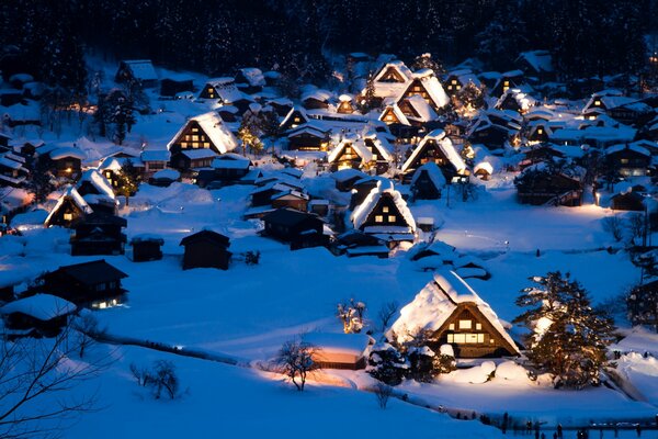 Casas en la noche de invierno en la nieve