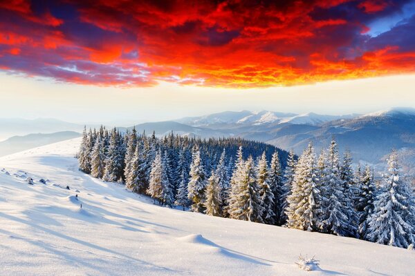 The glow in the sky over the snow-capped mountains in the snow