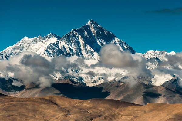 Icy mountains with white cumulus clouds