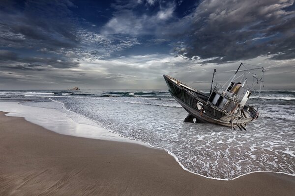 An old rocking boat near the shore