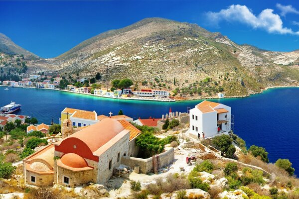 Houses and churches by the sea in sunny Greece