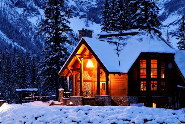 A house in winter nature among mountains and trees ьев