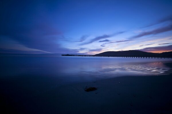 Tramonto scottante sul mare-vista dal molo