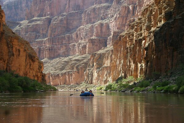 River, rocks boat people are sailing in a boat