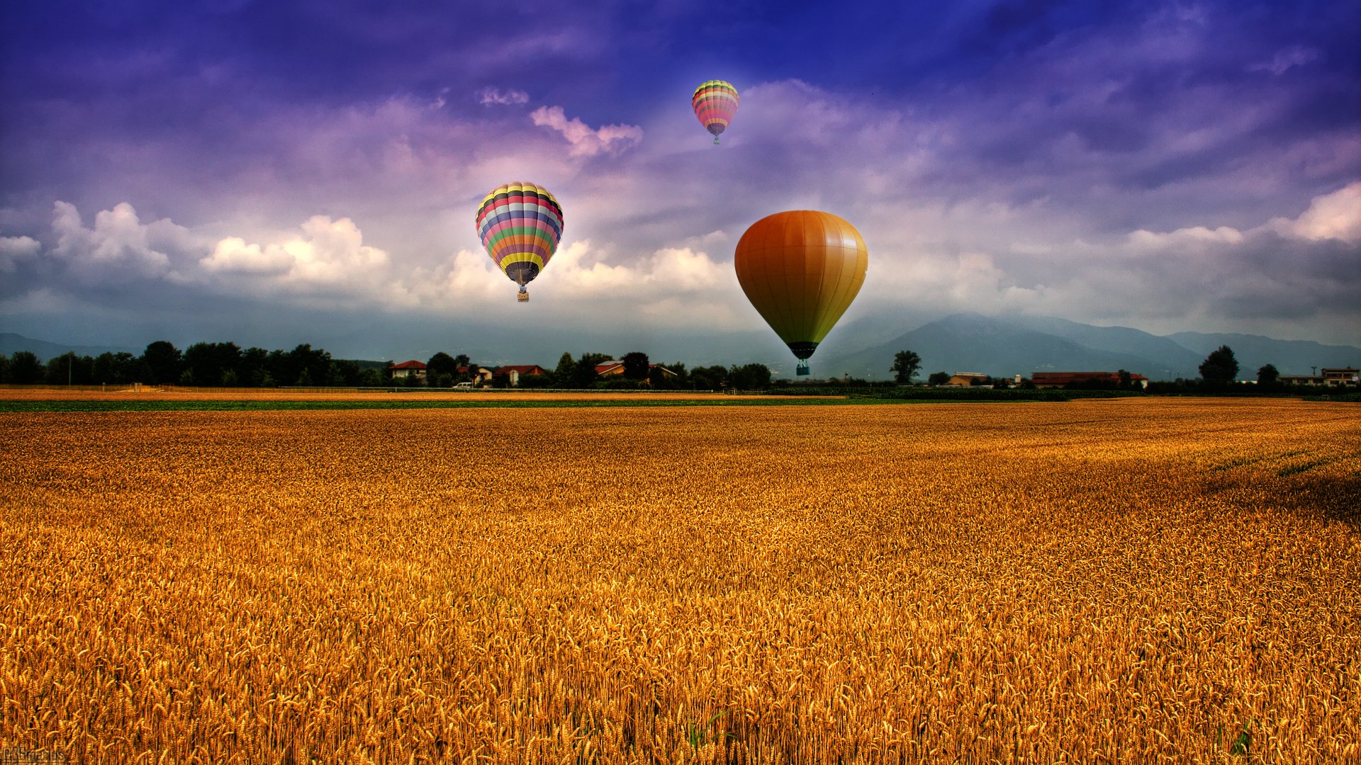 champ ballons ciel nuages montagnes maisons village