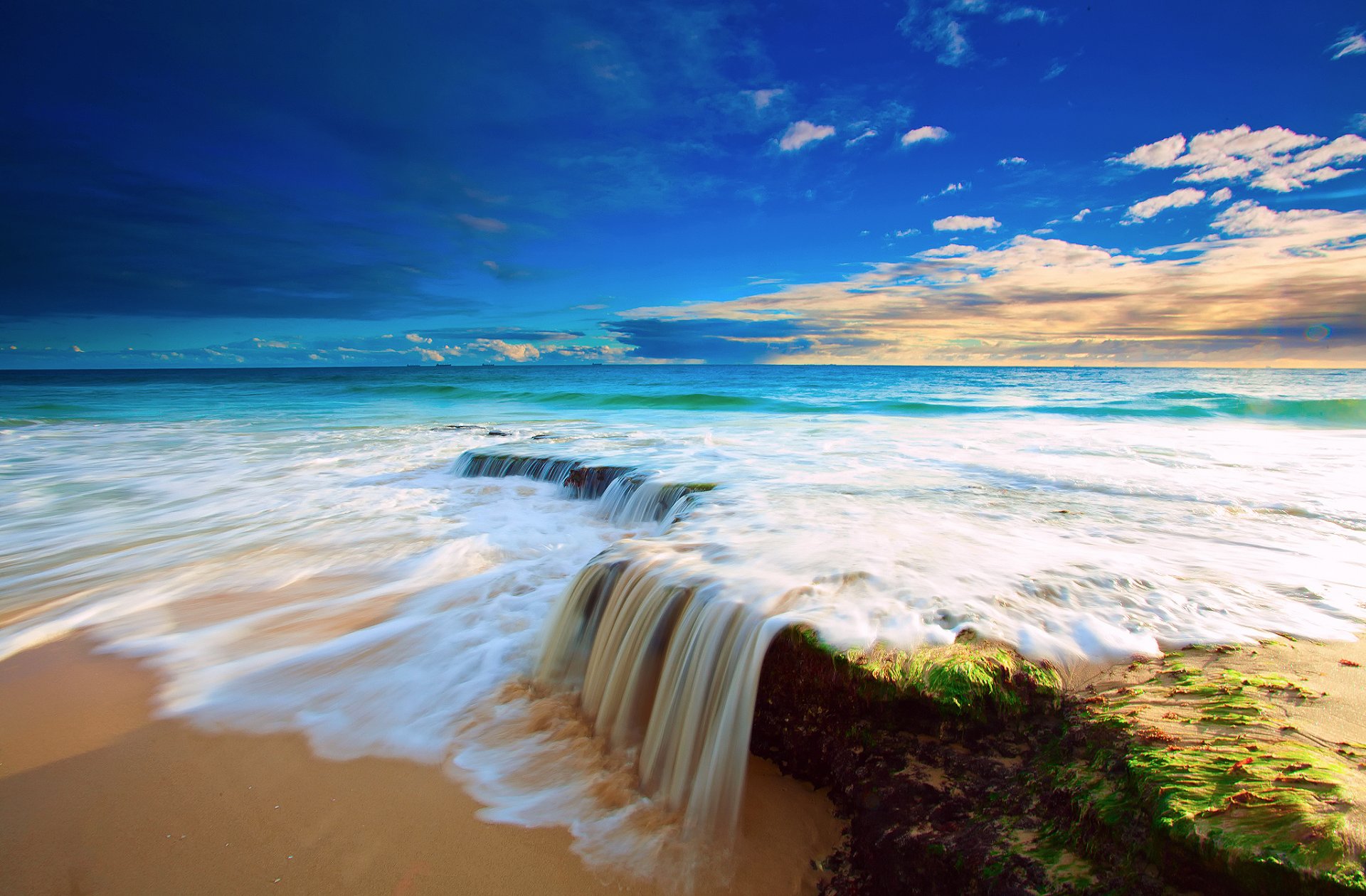 ea sky clouds water feed beach waterfall stone