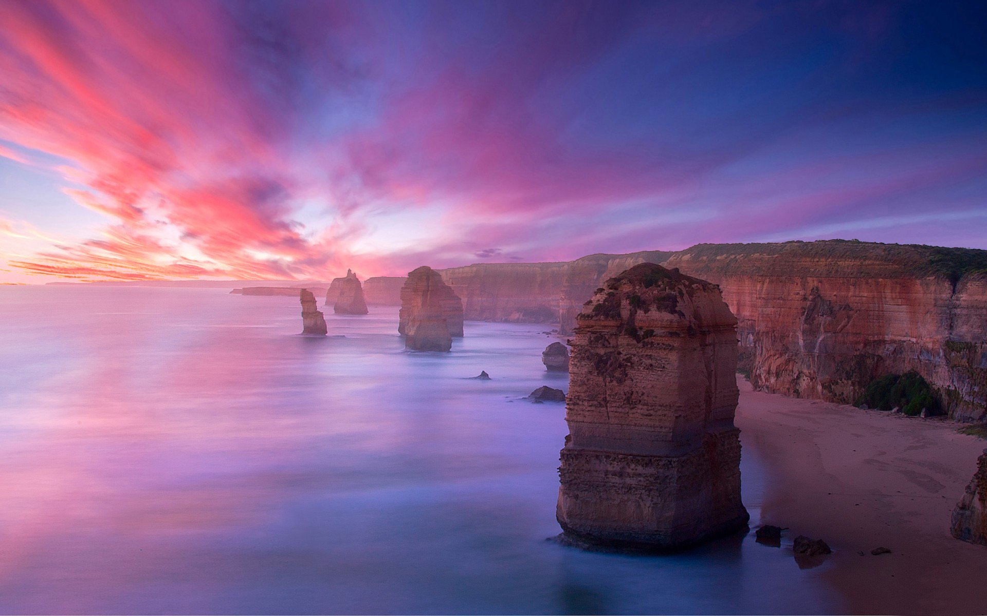 mountain rock reefs stones coast beach sand relief the distance horizon sky clouds sunset