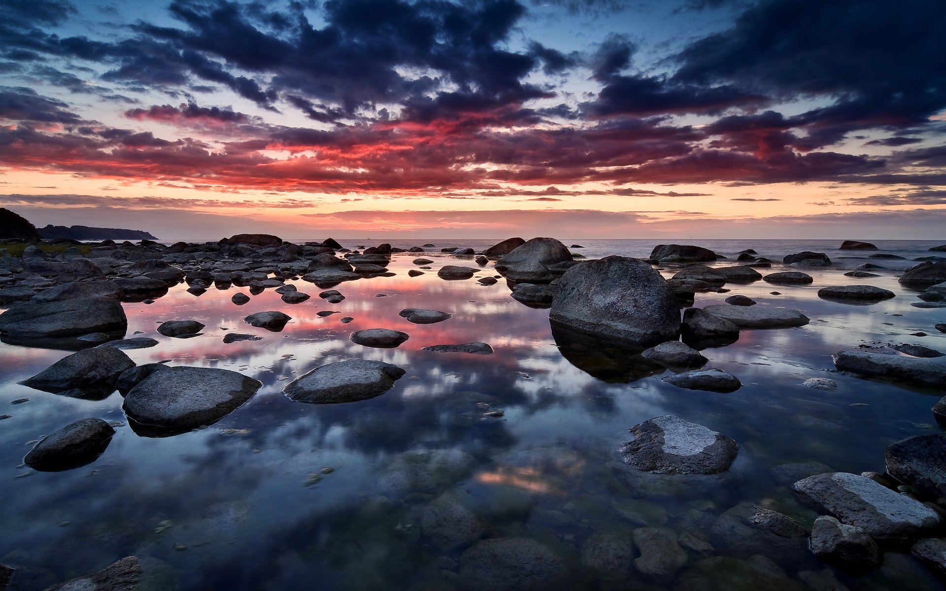 unset sky clouds reflection sea stones germany