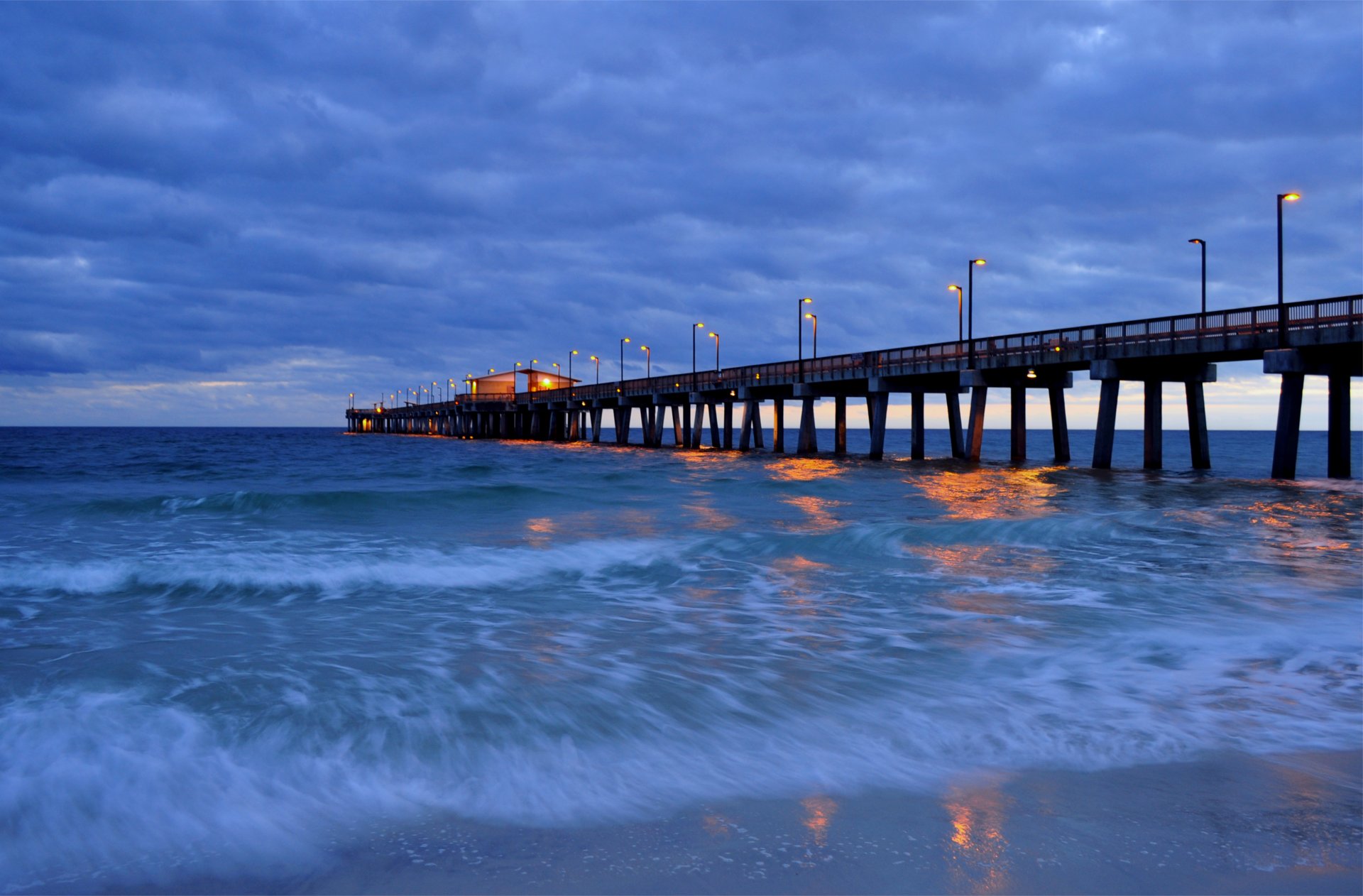 night blue sky clouds sea waves beach bridge pier light lights lamp