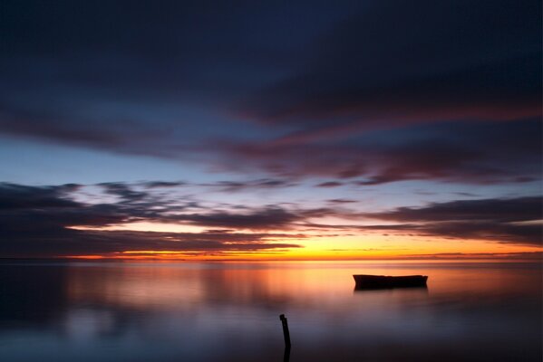 Bateau sur le lac au coucher du soleil du soir