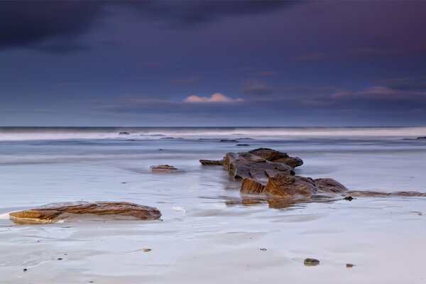 Dark sky over the blue sea