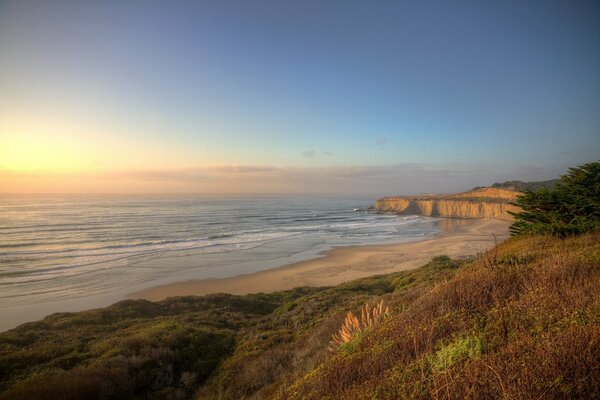 Sandy beach on the ocean , sunset on the ocean