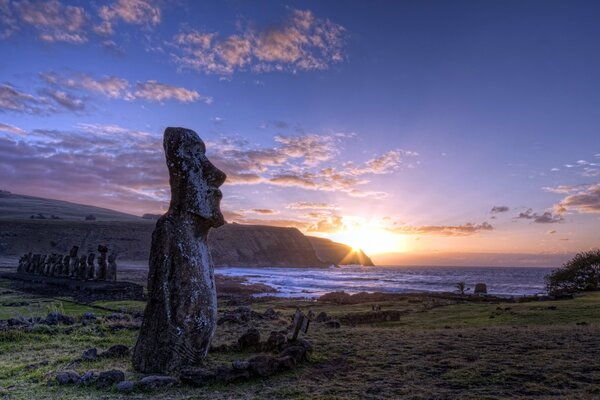 Idols on the background of the sea and sunset