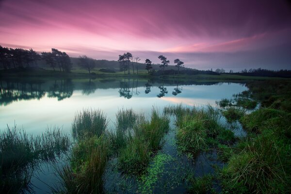 Rushing red sunset over the lake