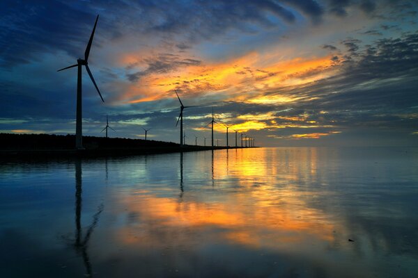 Twilight windmills on the background of water