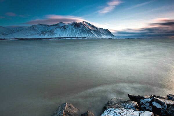 Rocks on the ocean coast and snow