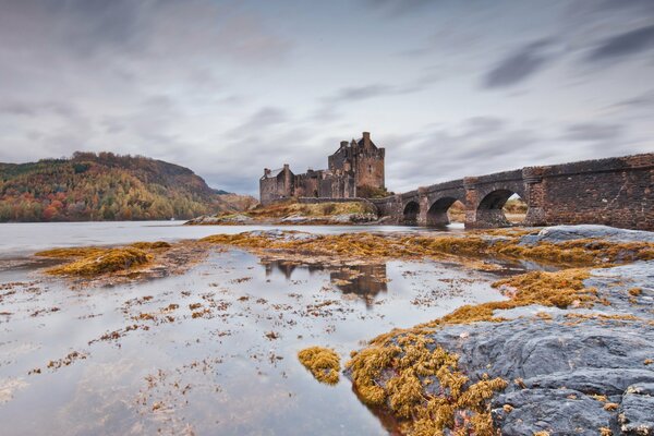 Ancient autumn castle with a bridge