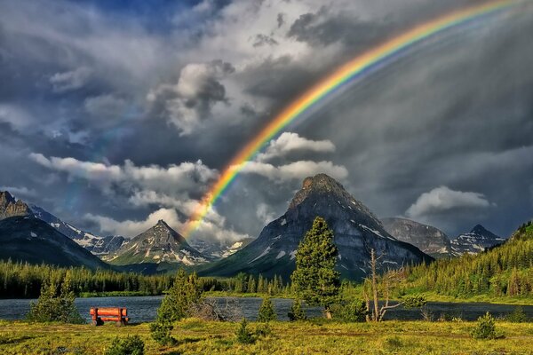 A beautiful rainbow among the gloomy sky in the mountains