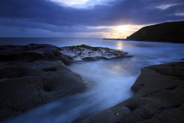 The evening sea located between the mountains on the edges