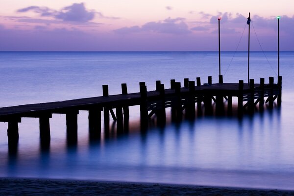 Wooden pier on the background of twilight