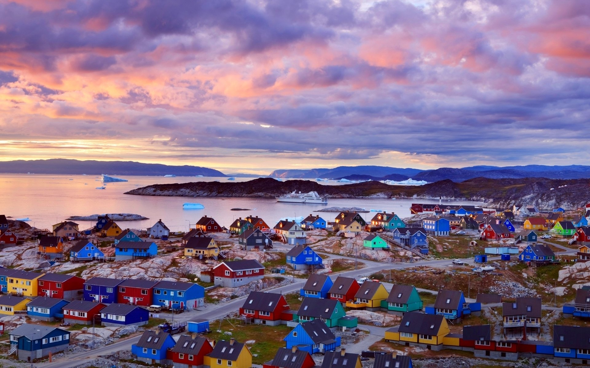 greenland beach ice floes ferry houses colored mountain clouds sunset pink