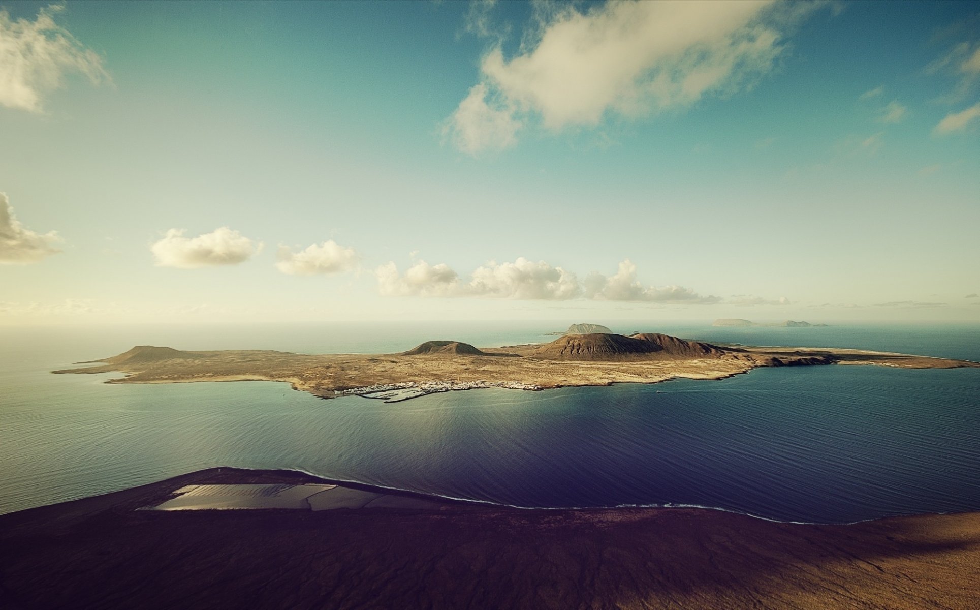 photo sea island mountain hills water sky clouds height landscape