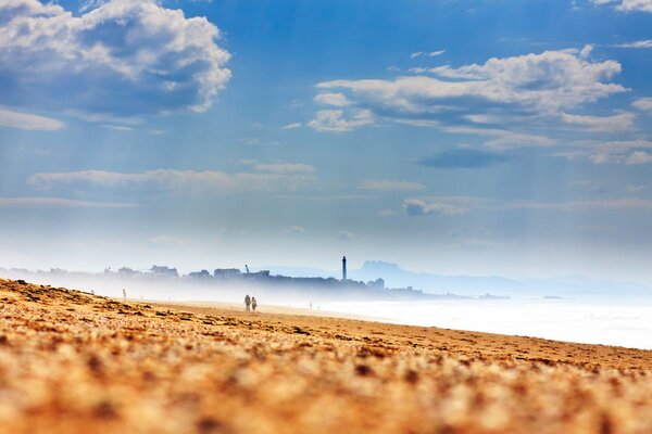 Lighthouse in a foggy haze on the sandy coast of France