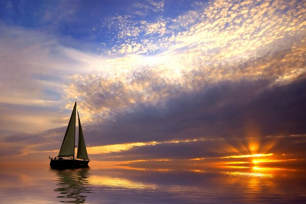 Ein einsames Segelboot, das bei Sonnenuntergang schwimmt