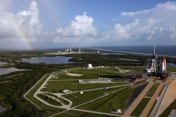 Cosmodrome rocket roads sky rainbow