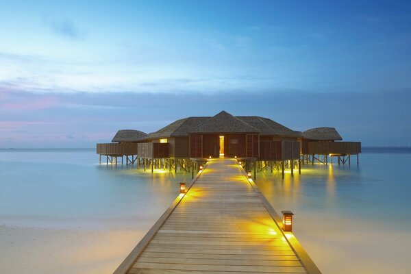 A house with a bridge on the seashore