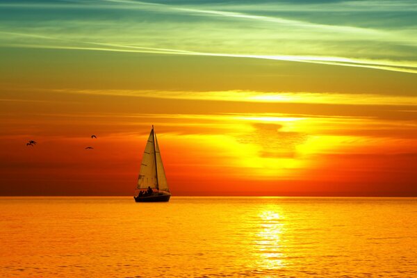 The bright sun shines on the sail in the sea