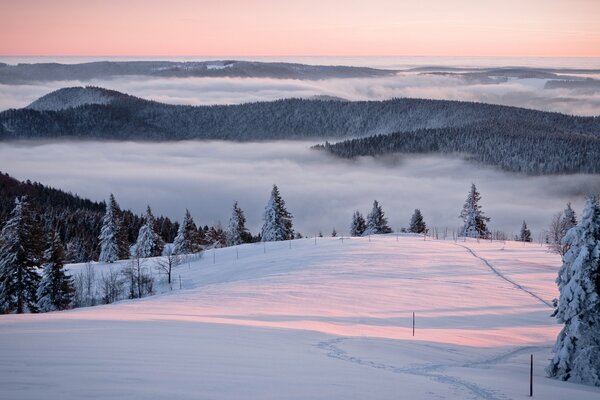 Pink sunset over a mountain panorama in winter