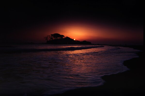 Gloomy sunset by the sea with shadows from the island