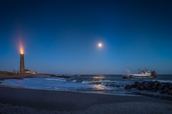 A ship at sea in the light of a full moon