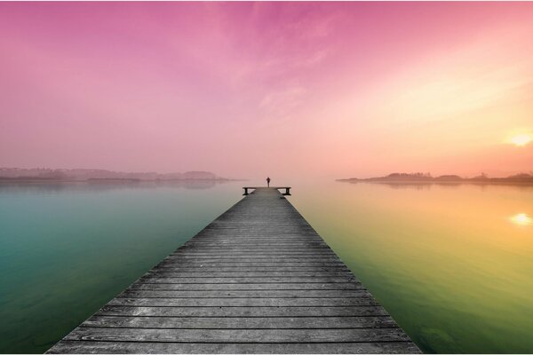 Lake pier leading to the pink dawn