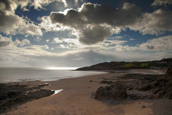 The beach where the sea rocks sand