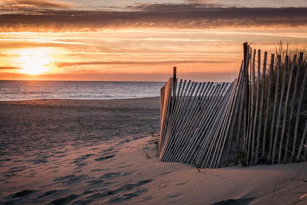 A leaning fence on the seashore