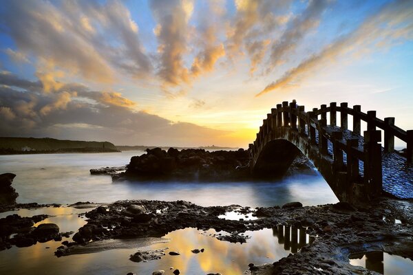 Beautiful unusual bridge, fantastic beautiful bridge, dawn and unusual bridge, fantastic landscape and bay