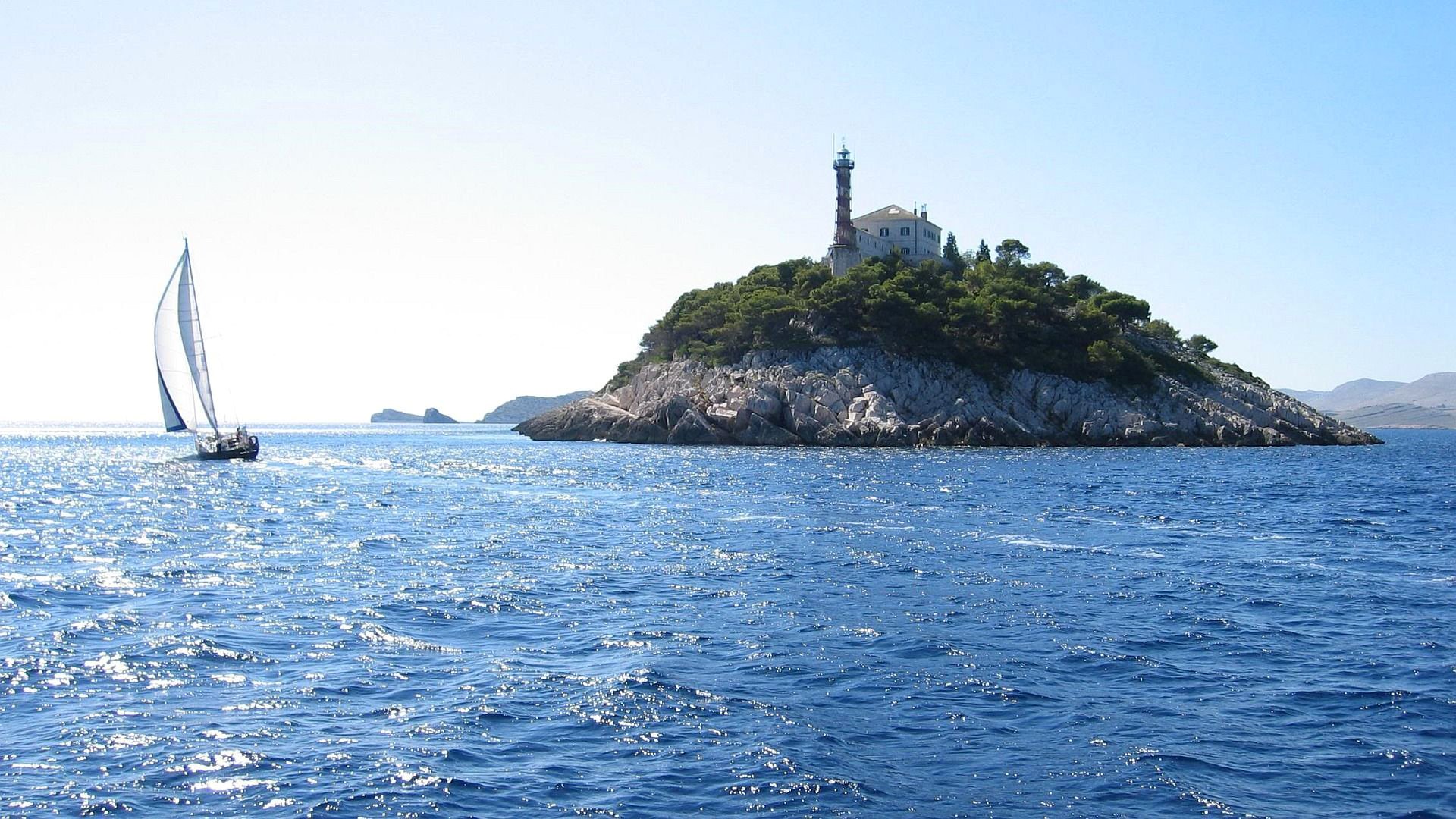 cielo mar isla roca faro barco vela