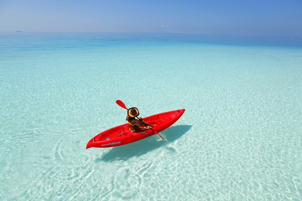 A girl on a kayak in the ocean