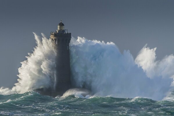 Sea waves break on the lighthouse