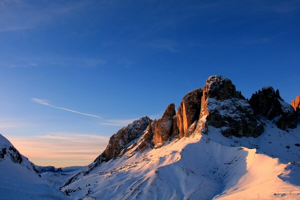 Mountain ranges in the snow against the sky