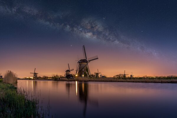 Dutch windmills on the Milky Way background