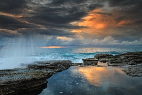 Sunrise landscape on the background of waves