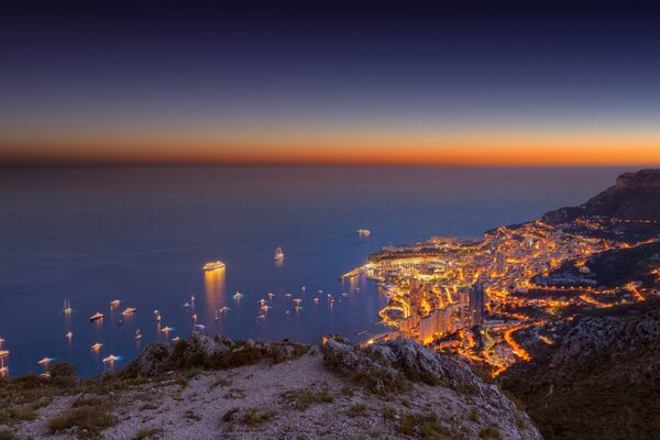 Yachts on the background of sunset off the coast of Monte Carlo