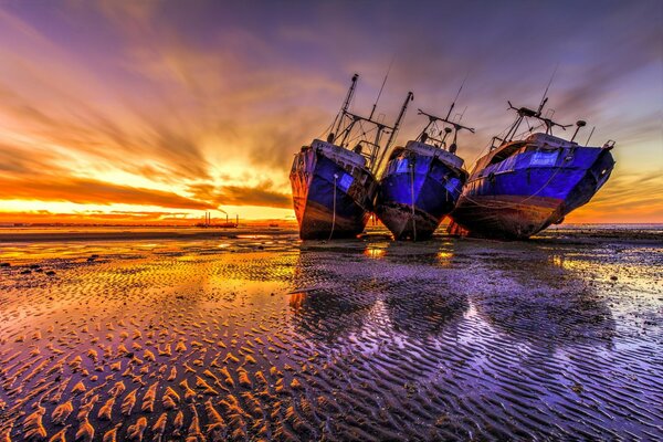 Majestic sea sunset and three empty ships